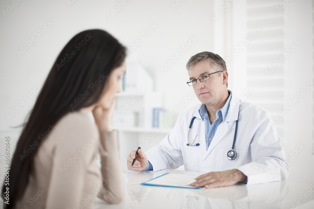 senior doctor consulting female patient senior doctor consulting female patient