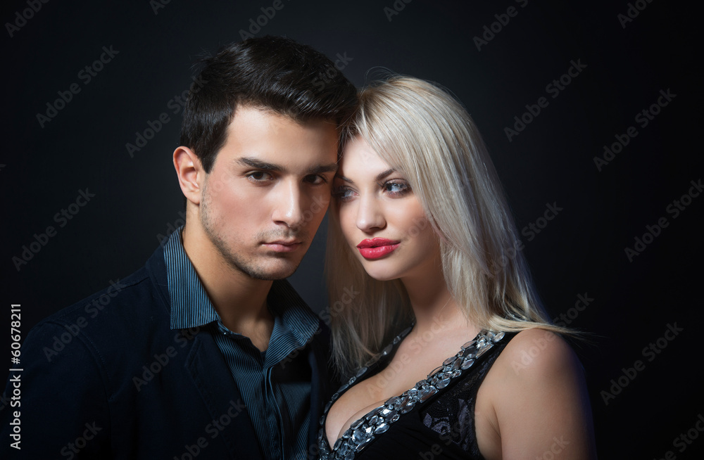 Portrait of a handsome young couple on dark background Portrait of a handsome young couple on dark background