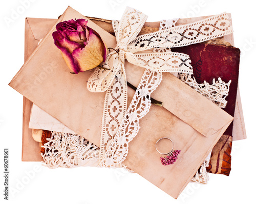 Old letters and notebook tied with lace ribbon.