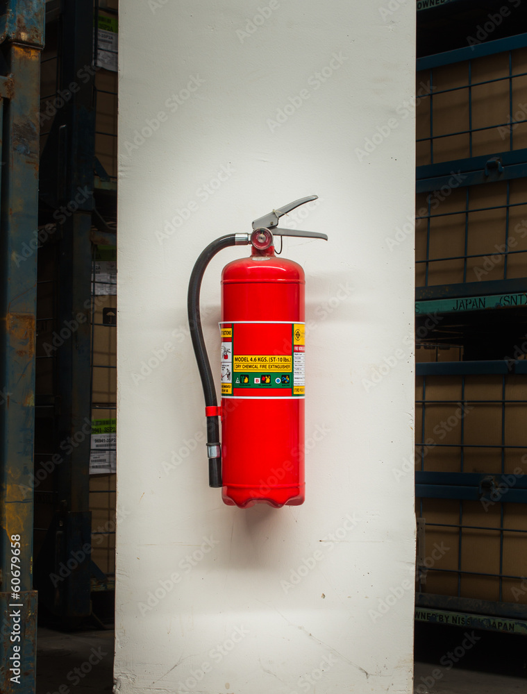 Red fire extinguisher in the warehouse Red fire extinguisher in the warehouse