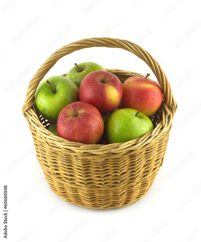 Ripe green and red apples in brown wicker basket isolated Ripe green and red apples in brown wicker basket isolated