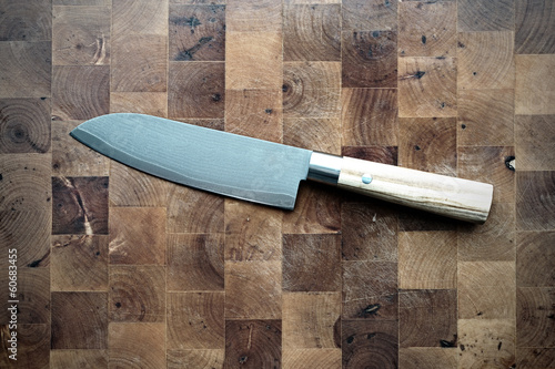 Damask Santoku Kitchen Knife on Used Cutting Board photo