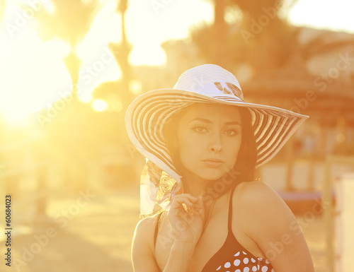 Sexy bikini woman in hat  looking hot on the beach