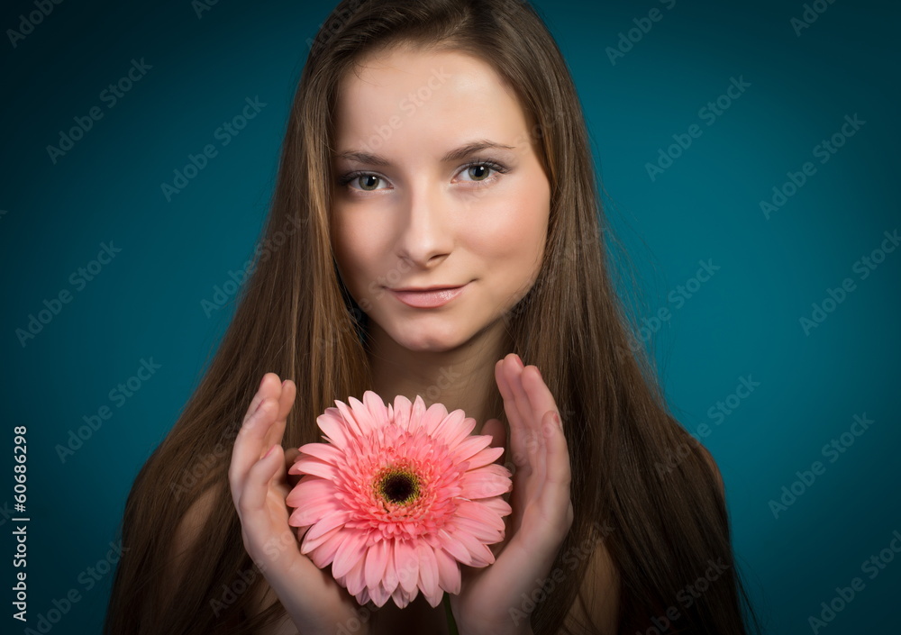 Young pretty woman with pink flower in her hands. Young pretty woman with pink flower in her hands.