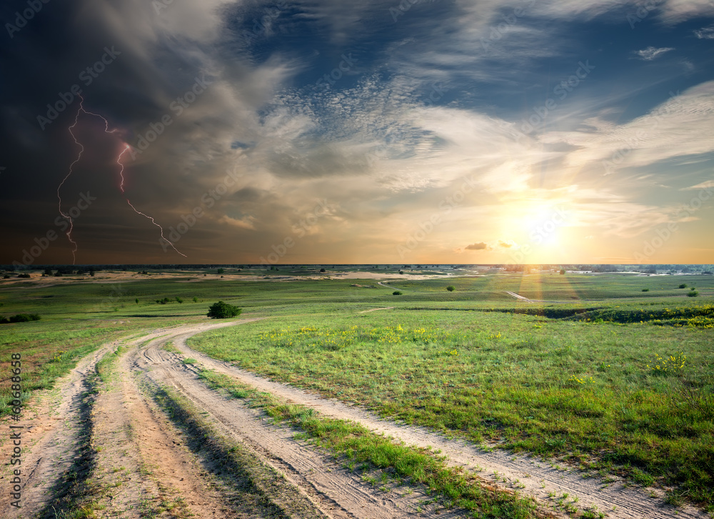 Storm over the road in field