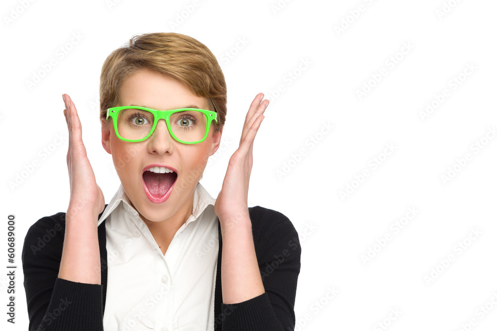 Portrait of surprised young woman in green glasses.