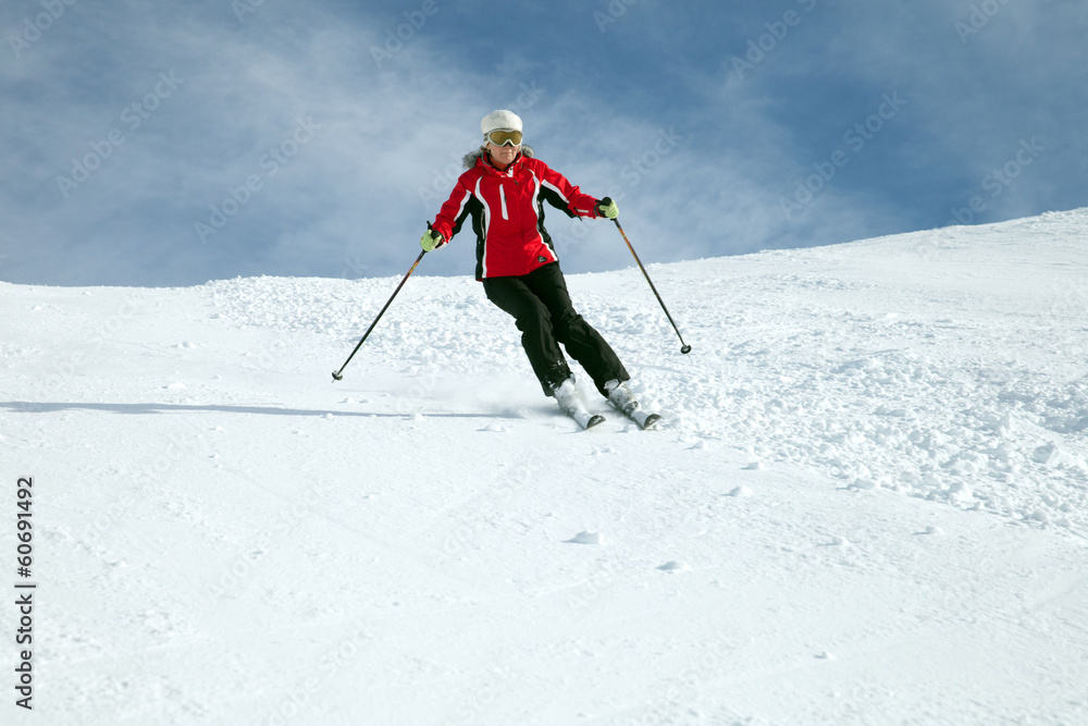Skier in mountains against blue sky Skier in mountains against blue sky