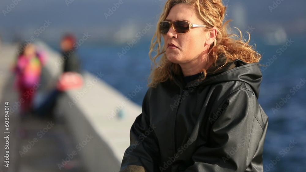 thoughtful blonde women smoking cigarette at near sea thoughtful blonde women smoking cigarette at near sea