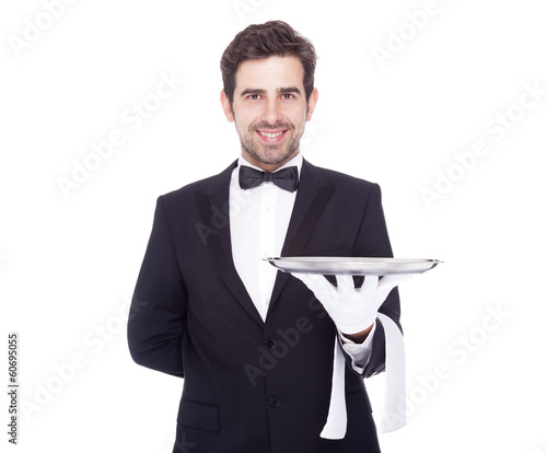 Handsome waiter holding an empty silver tray, isolated on white photo