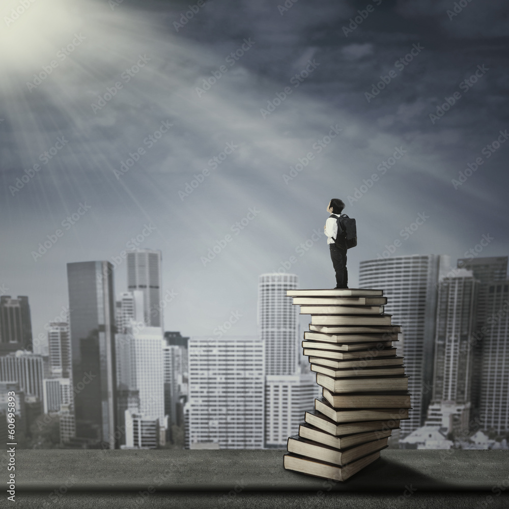 Child standing on a stack of books Child standing on a stack of books