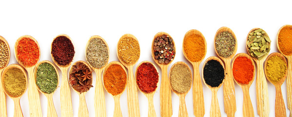 Fototapete Gewürze Assortment of spices in wooden spoons, isolated on white  © Africa Studio