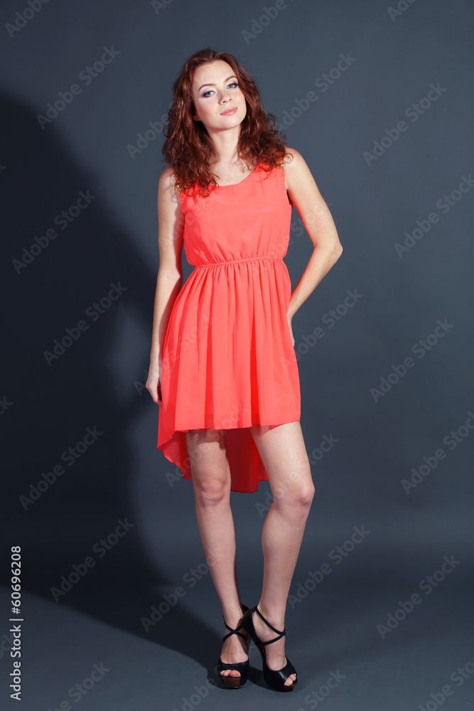 Beautiful young girl in dress on grey background Beautiful young girl in dress on grey background