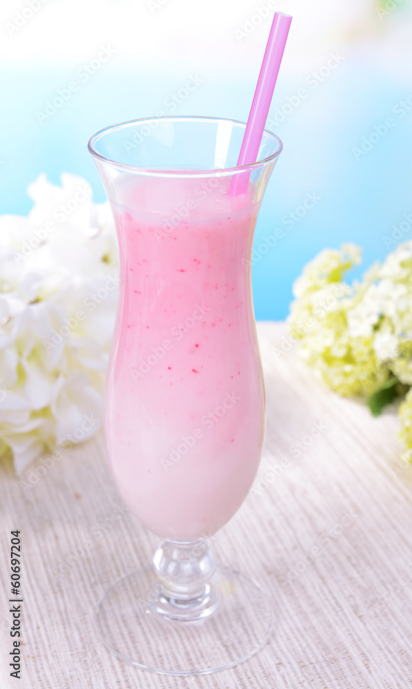 Milk shake on table on light blue background Milk shake on table on light blue background
