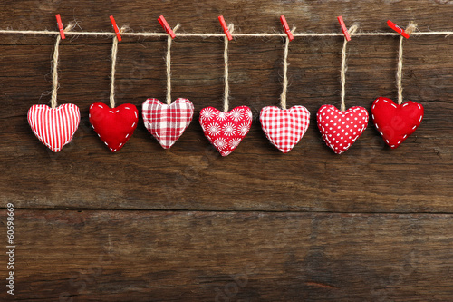 Gingham Love Valentine's hearts hanging on wooden texture backgr