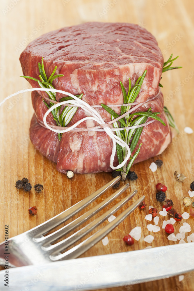 fresh raw beef fillet mignon on old  wooden background