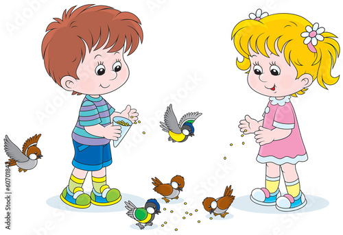 children feed a small flock of sparrows and titmice