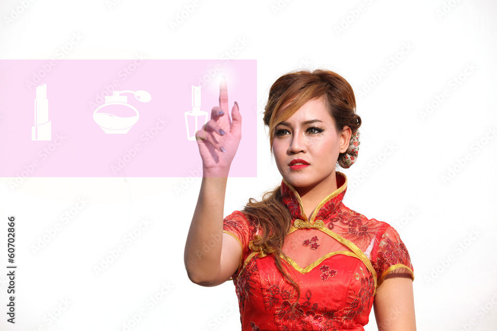 Woman in Chinese dress selects cosmetic on touch screen Woman in Chinese dress selects cosmetic on touch screen