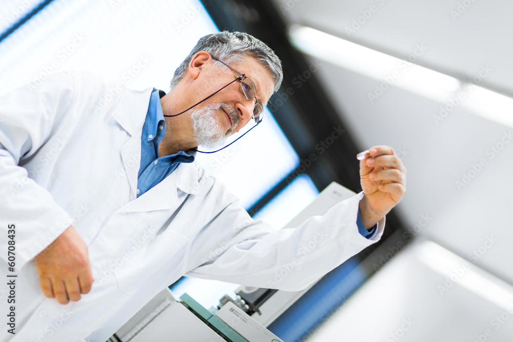 Senior male researcher carrying out scientific research in a lab Senior male researcher carrying out scientific research in a lab