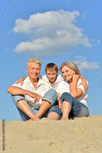 happy family relaxing on the sand together