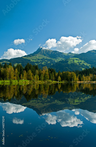 Wharf by the Schwarzsee in Austria with mirror reflection