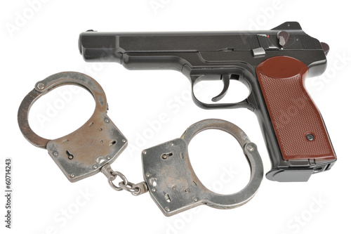 Pistol with handcuffs isolated