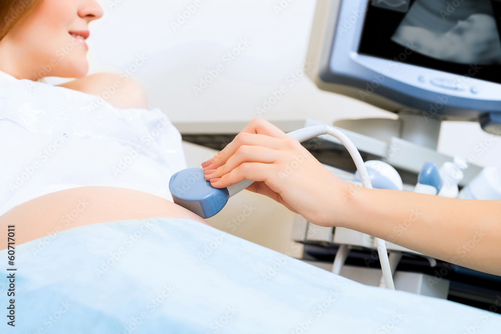 close-up of hands and abdominal ultrasound scanner close-up of hands and abdominal ultrasound scanner