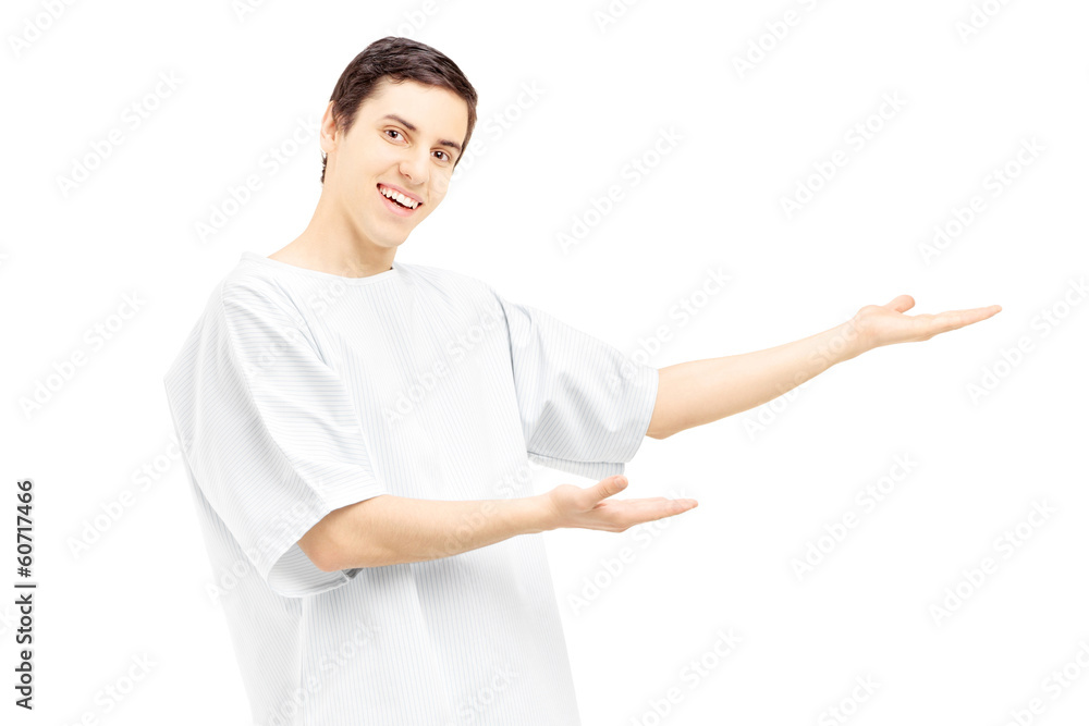 Male patient in a hospital gown gesturing with his hands Male patient in a hospital gown gesturing with his hands