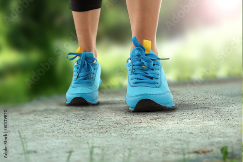 running shoes of blue color in green space