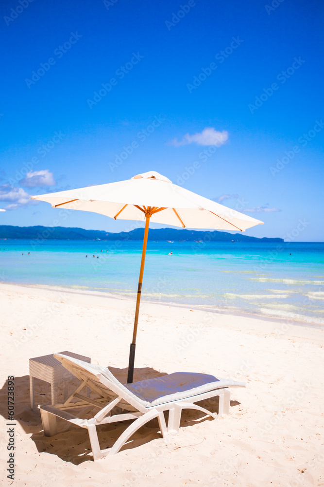 Two chairs and umbrella on stunning tropical beach