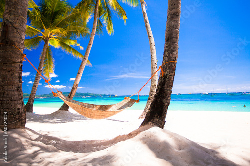 View of cozy straw hammock on the tropical white beach