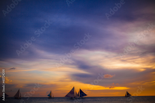 Small sailboats on the beautiful sunset in the Philippines