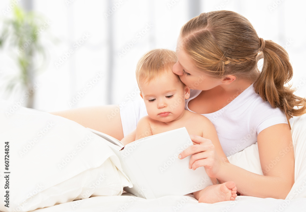 Mother reading book baby in bed before going to sleep Mother reading book baby in bed before going to sleep