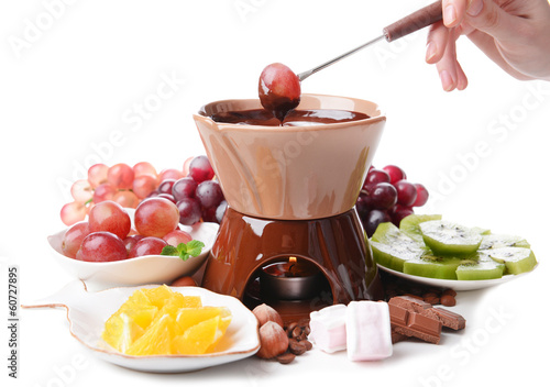 Chocolate fondue with marshmallow candies and fruits, isolated