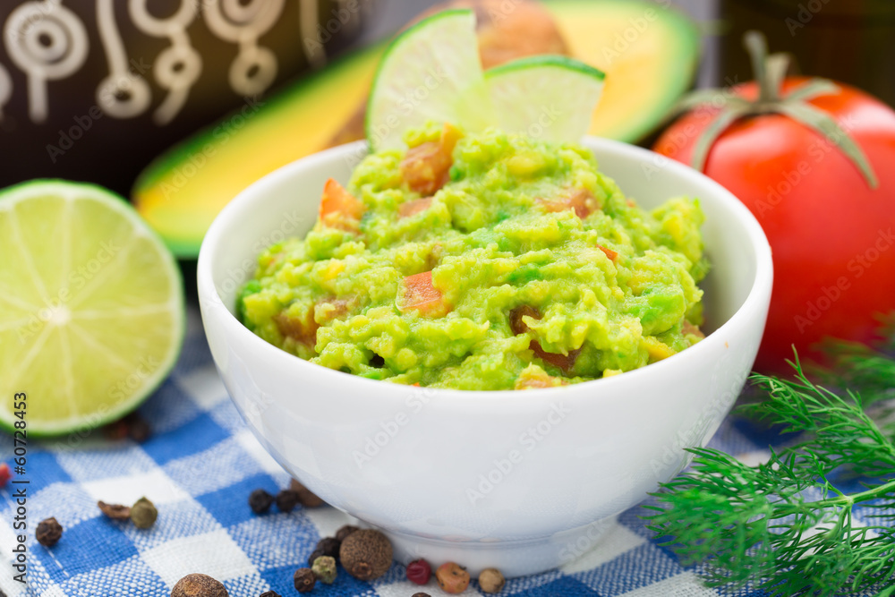 Obraz premium Guacamole with avocado, lime, tomato