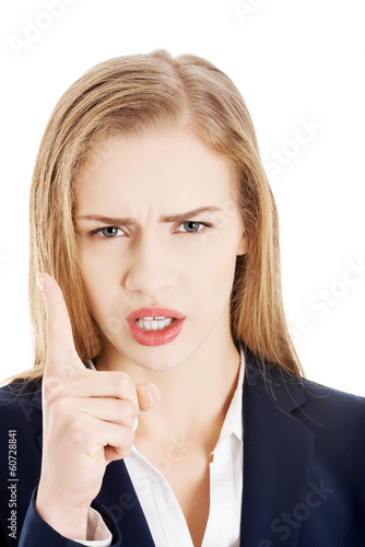 Beautiful caucasian business woman shows warning gesture.