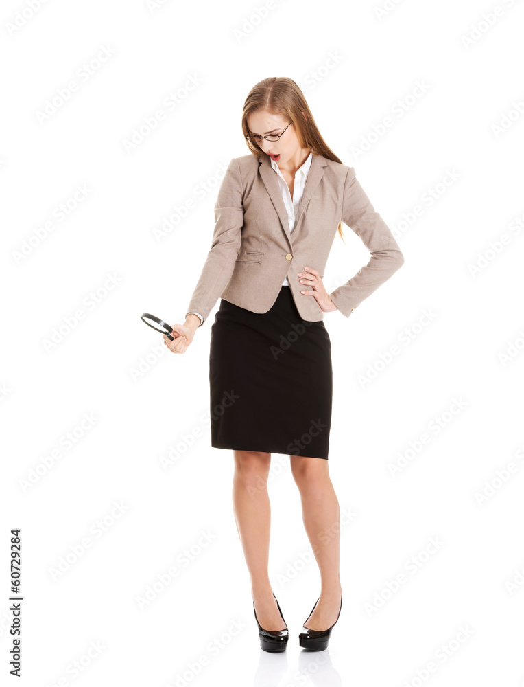 Beautiful business woman looking through magnifying glass. Beautiful business woman looking through magnifying glass.