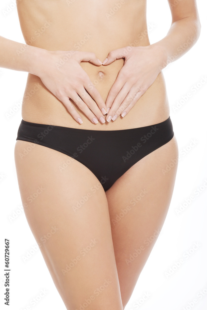 Woman is having heart shape made from hands on her belly. Woman is having heart shape made from hands on her belly.