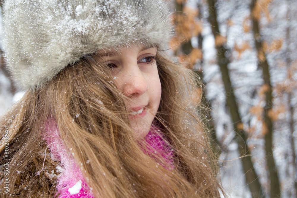 Happy little girl in warm hat - closeup portrait Happy little girl in warm hat - closeup portrait