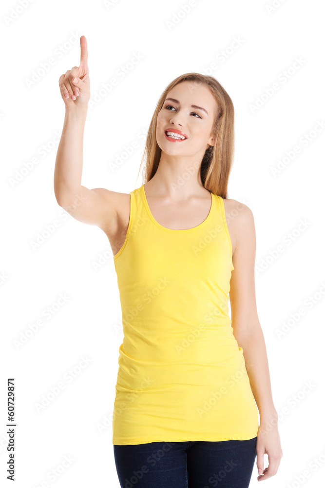 Beautiful caucasian casual woman pointing up on copy space. Beautiful caucasian casual woman pointing up on copy space.