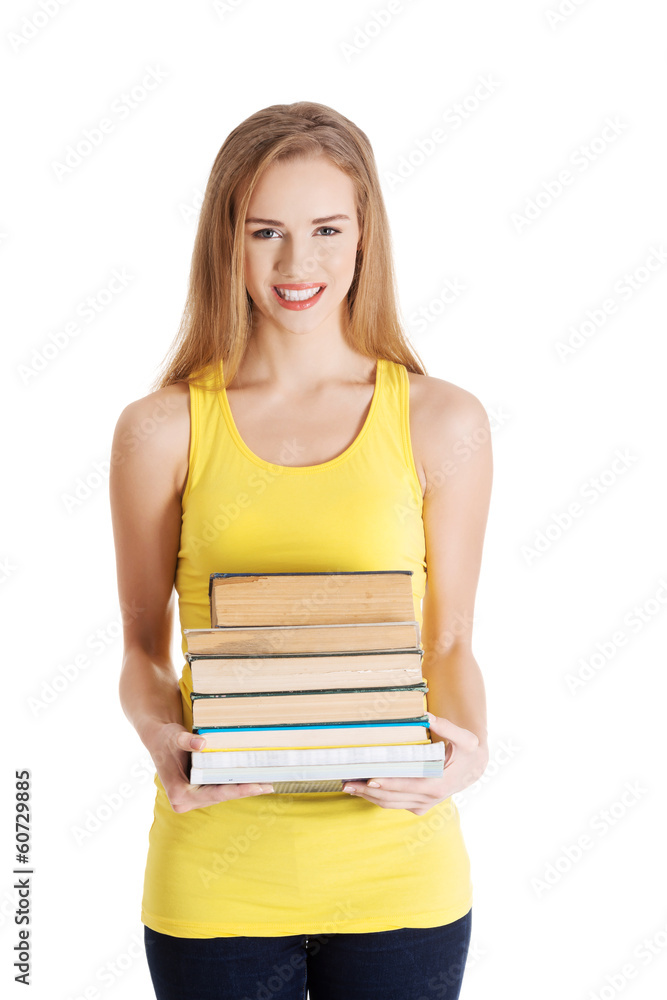 Beautiful casual caucasian woman student holding stack of books. Beautiful casual caucasian woman student holding stack of books.