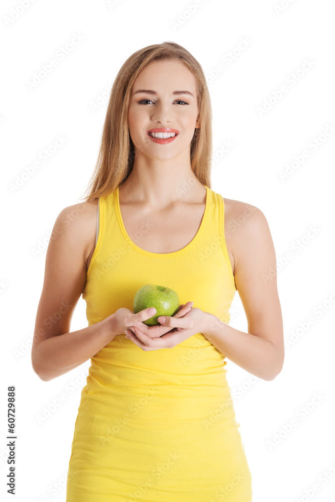 Beautiful casual caucasian woman holding fresh green apple.