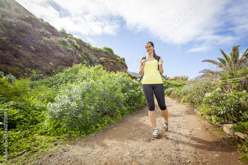 young woman hiking happy in tropical nature