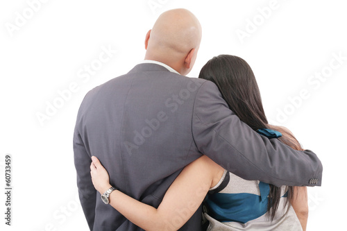 Back view of couple hug and look into a distance. formal guy and
