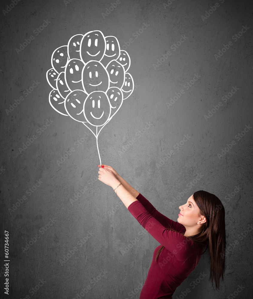 Woman holding a bunch of smiling balloons Woman holding a bunch of smiling balloons