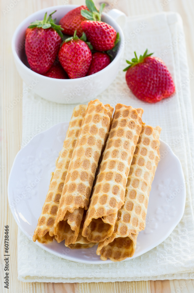 Homemade waffle with strawberry on a wooden surface Homemade waffle with strawberry on a wooden surface