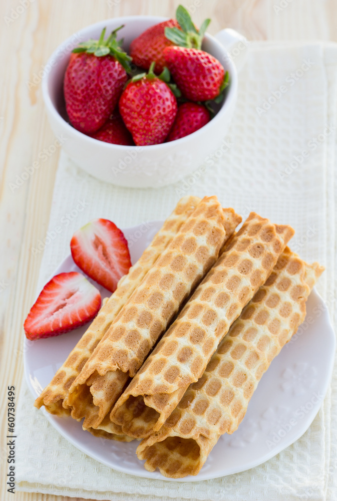 Homemade waffle with strawberry on a wooden surface Homemade waffle with strawberry on a wooden surface
