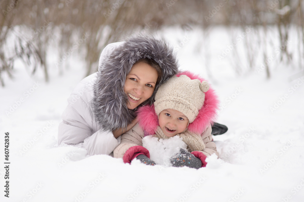 Mother and daughter  in the snow.