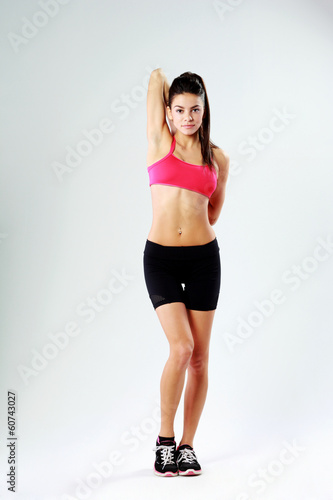 sport woman standing on gray background