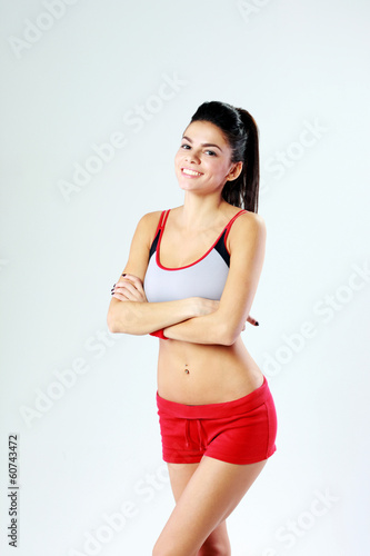 sport woman standing with arms folded on gray background