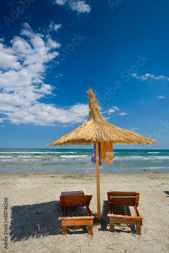 Beach chair on White sand blue sea background